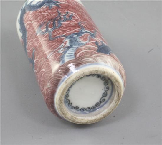 A Chinese underglaze blue and copper red dragon cylindrical snuff bottle, 19th century, height 8cm excl. stopper